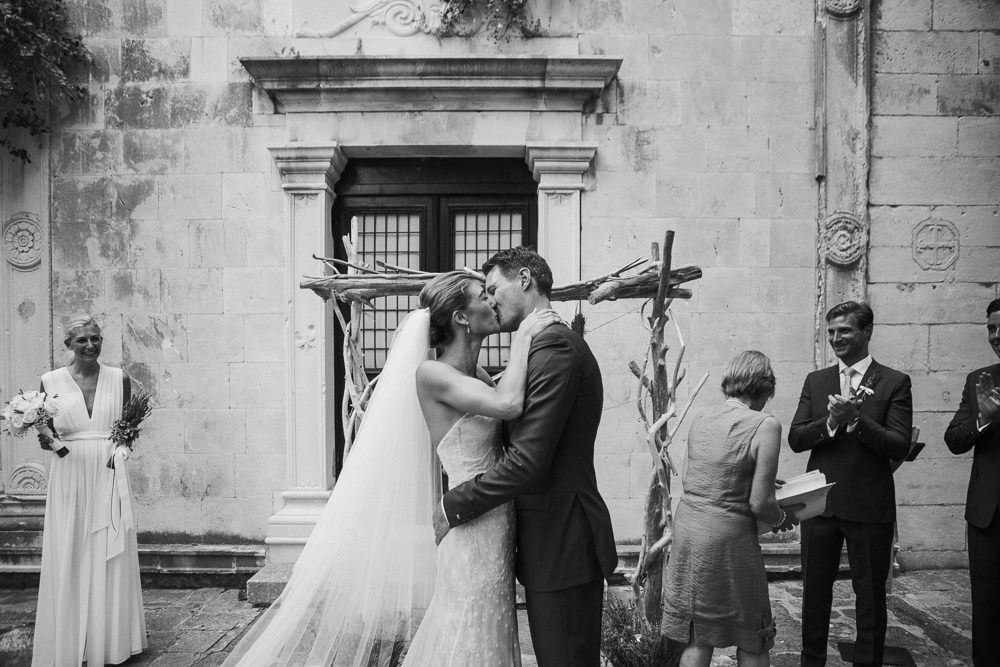 Bride and groom first kiss after the ceremony in Saint Mark church in Hvar in Croatia