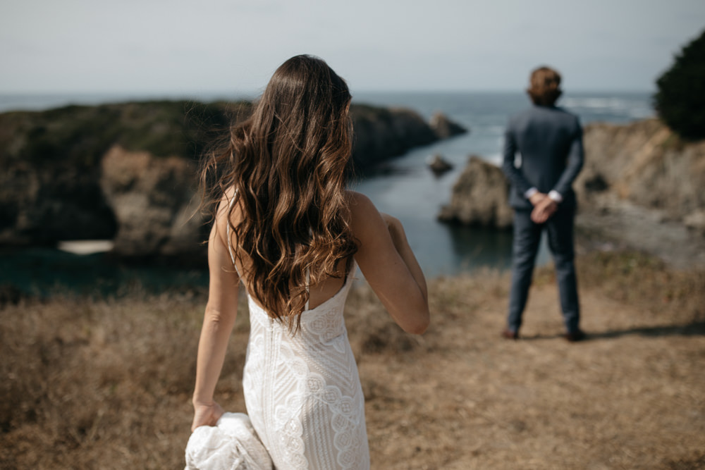 Bride and groom first look on the coastline of California
